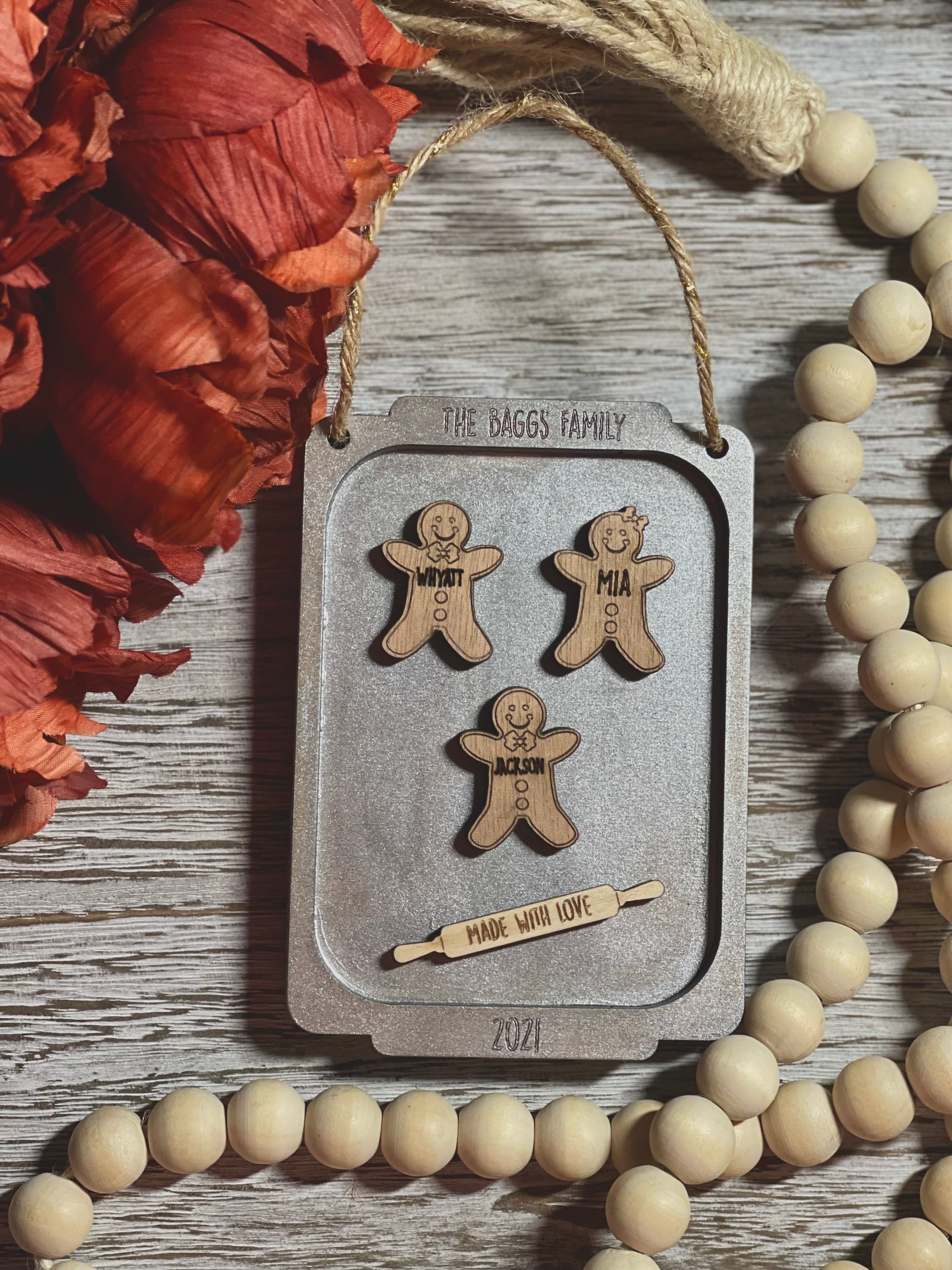 An ornament tray showcasing family members in gingerbread cookie form.