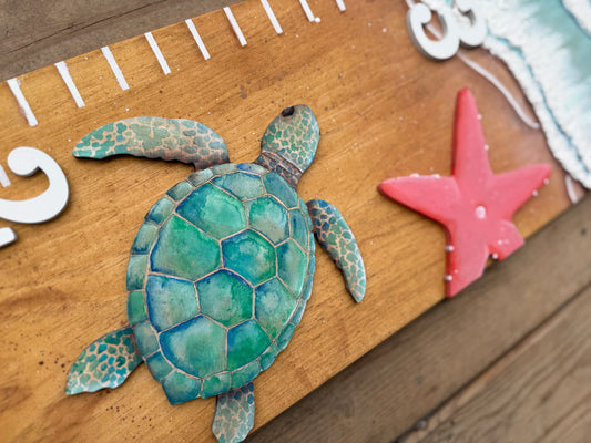 Decorative turtle and starfish on a wooden surface