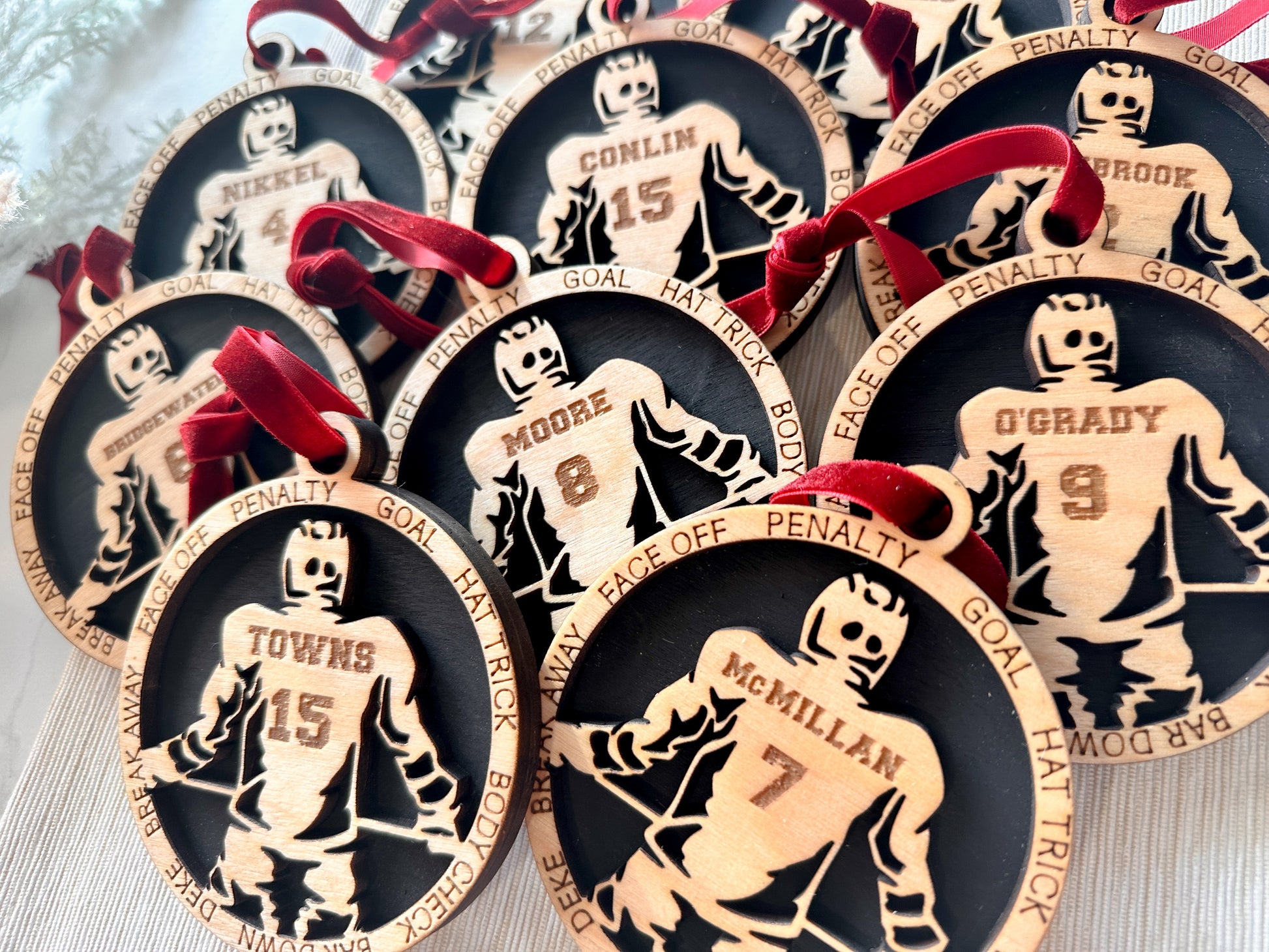 Commemorative ornaments featuring players last name and jersey number. The border features hockey related verbiage. 