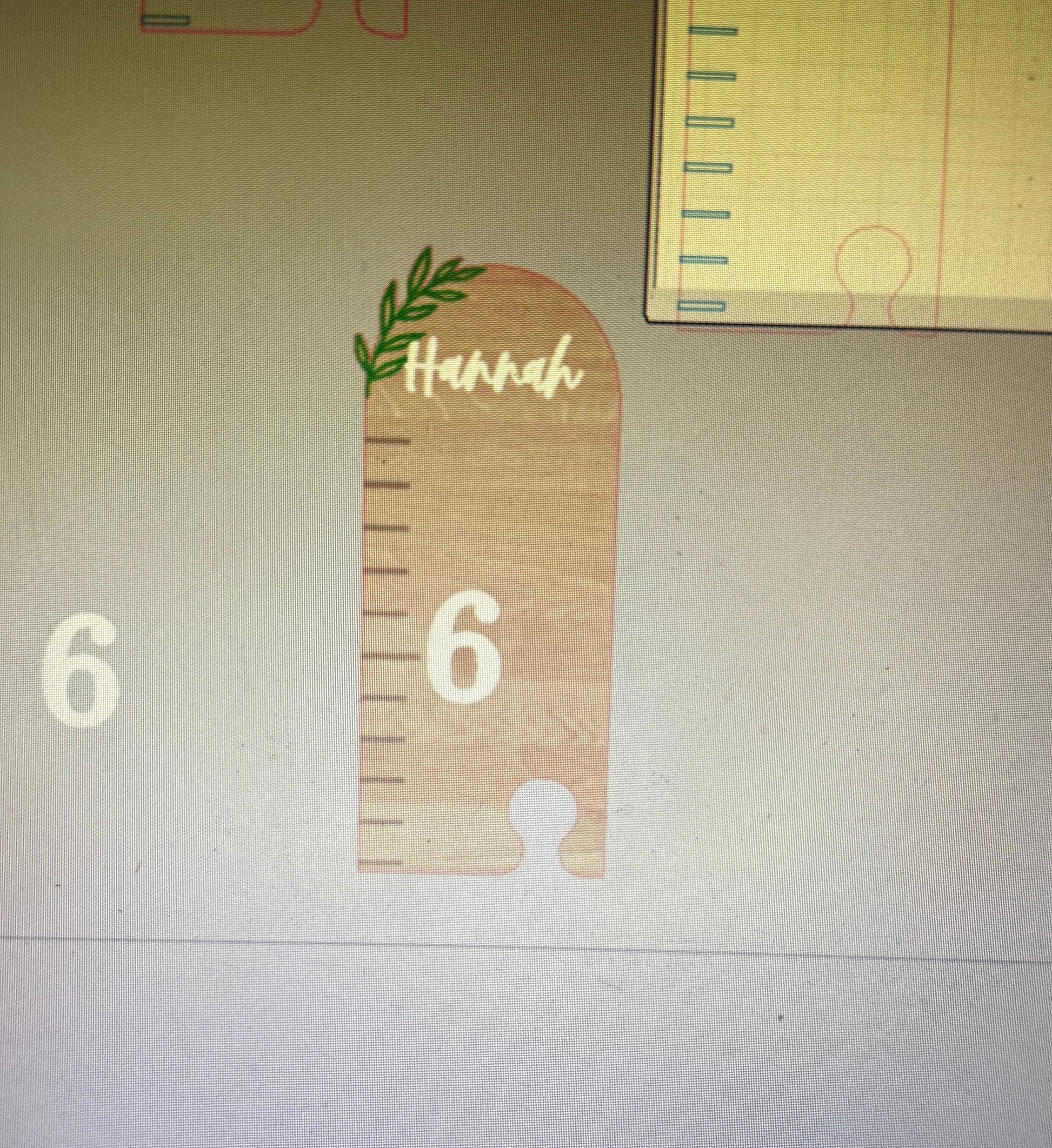 Wooden ruler-shaped object with 'Hannah' and number '6' on a light background