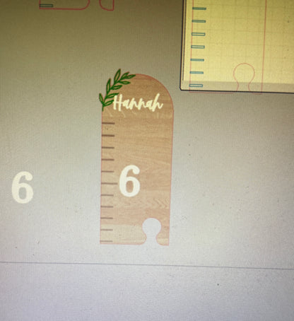Wooden ruler-shaped object with 'Hannah' and number '6' on a light background