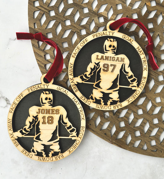 Commemorative ornaments featuring players last name and jersey number. The border features hockey related verbiage. 